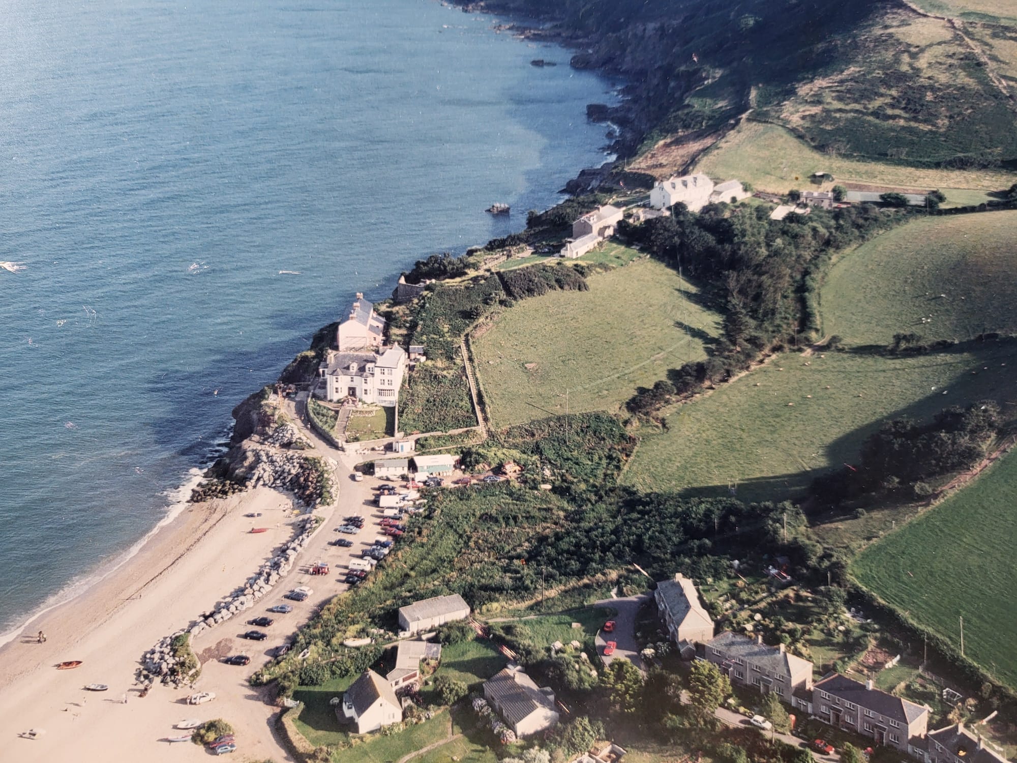 Aerial photo of the coast, a hotel on a cliff, farmland around