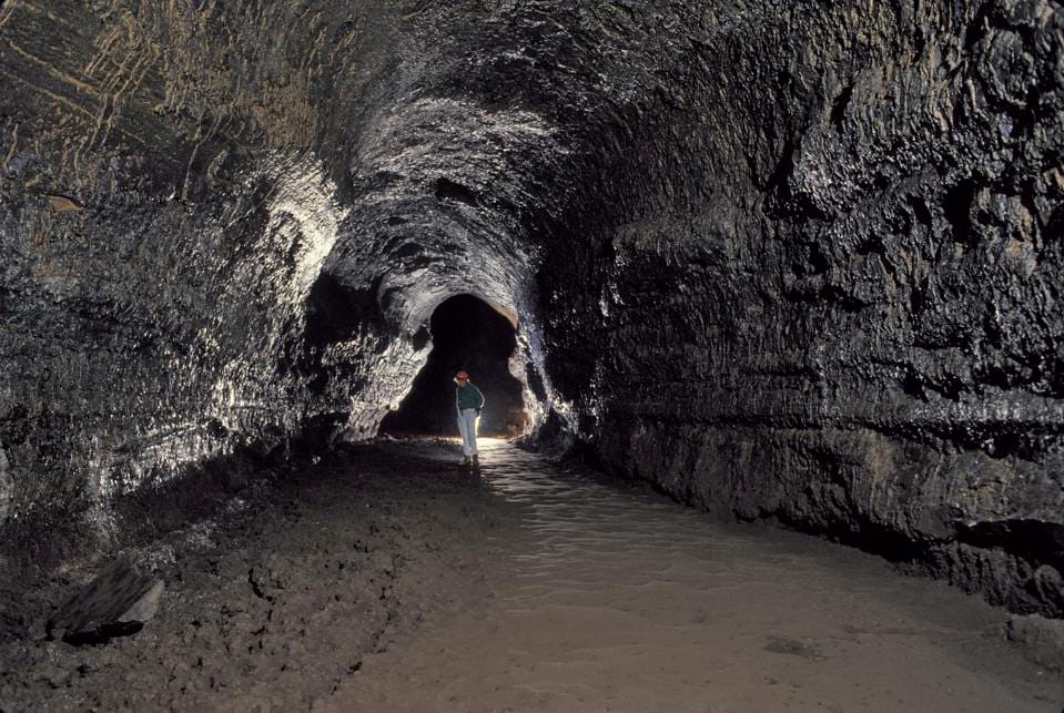 Person standing in a black lava tube