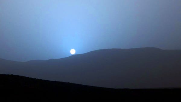 Blue sunset over dark dunes